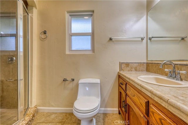 bathroom featuring tile patterned flooring, vanity, toilet, and a shower with door