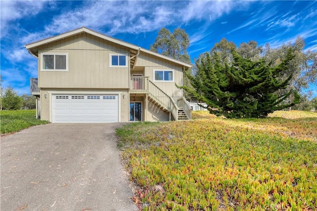 view of front of house with a garage and a front lawn