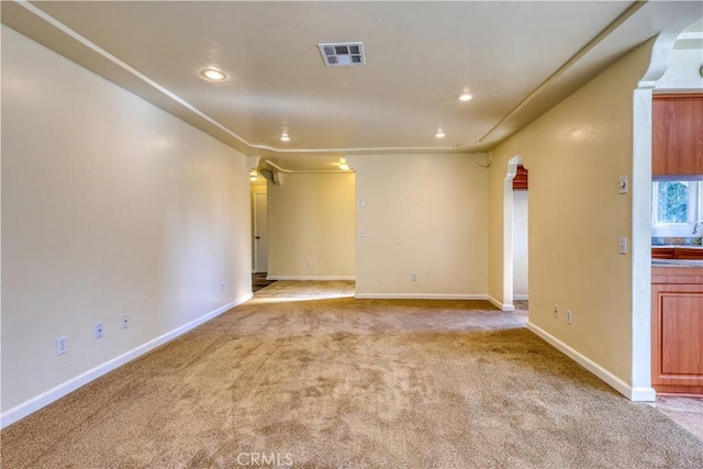 unfurnished room featuring light carpet