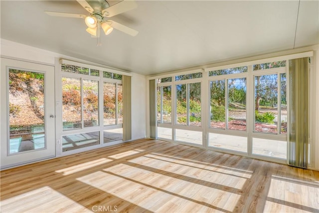 unfurnished sunroom with plenty of natural light and ceiling fan