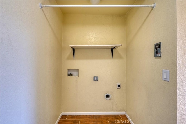 laundry room with dark wood-type flooring, washer hookup, and hookup for an electric dryer