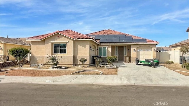 mediterranean / spanish house featuring solar panels and a garage