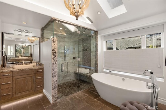 bathroom with plus walk in shower, vanity, lofted ceiling with skylight, and a healthy amount of sunlight