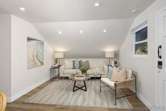 living room with lofted ceiling and hardwood / wood-style flooring