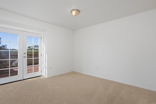 unfurnished room featuring french doors and carpet floors