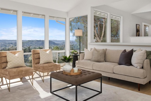 sunroom / solarium featuring lofted ceiling and a mountain view