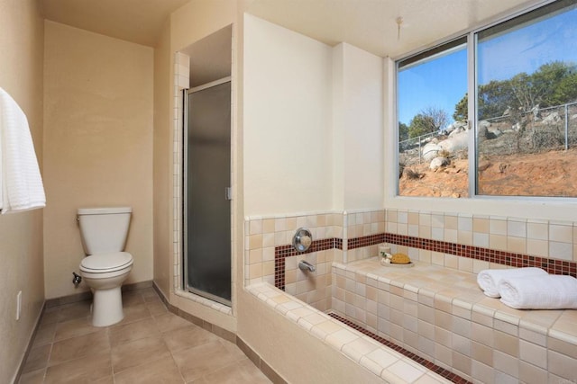 bathroom featuring toilet, plus walk in shower, and tile patterned flooring