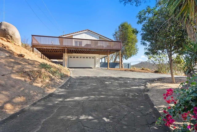 view of front of property featuring a wooden deck and a garage