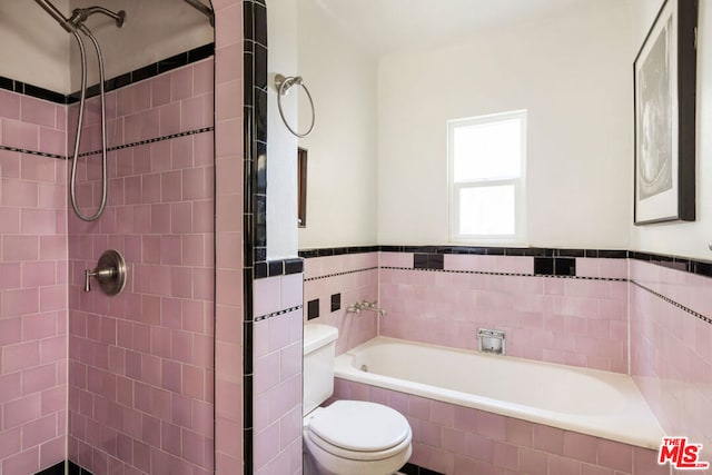 bathroom featuring independent shower and bath and toilet