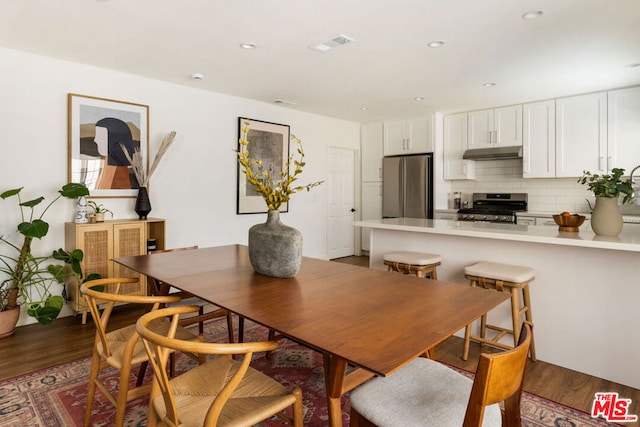 dining room with dark hardwood / wood-style flooring