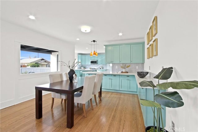 kitchen featuring tasteful backsplash, pendant lighting, and light hardwood / wood-style floors