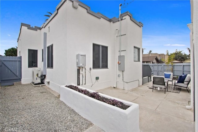 back of property with ac unit and a patio area