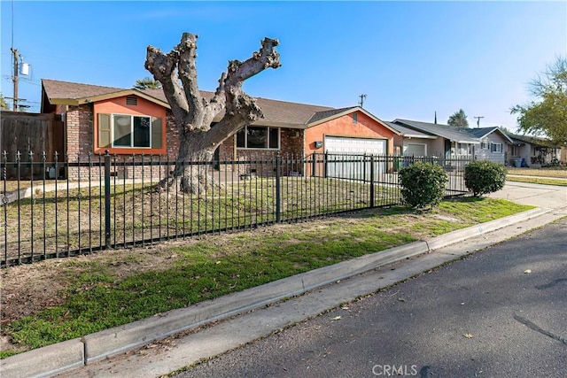 ranch-style house with a front yard and a garage