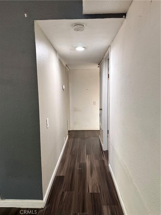 corridor featuring dark hardwood / wood-style flooring