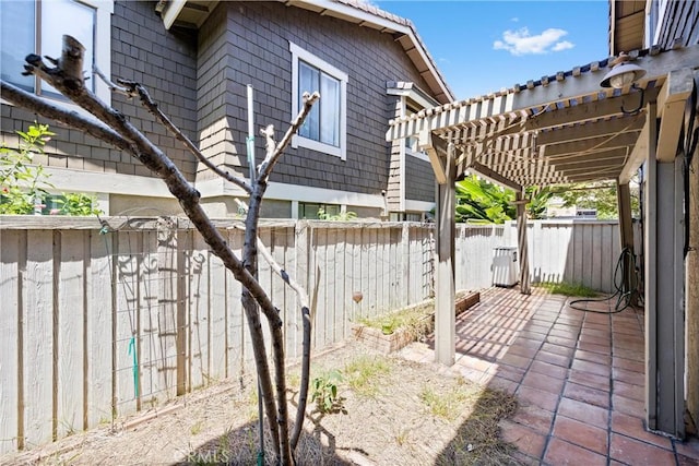 exterior space with a patio area, a fenced backyard, and a pergola