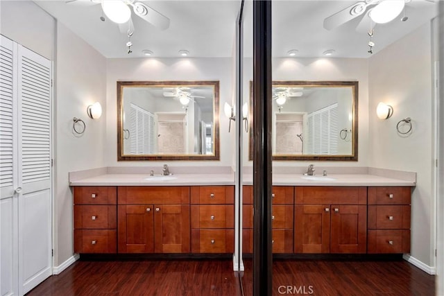 full bathroom featuring a closet, two vanities, a sink, and ceiling fan