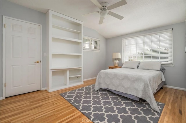 bedroom with wood-type flooring, vaulted ceiling, and ceiling fan