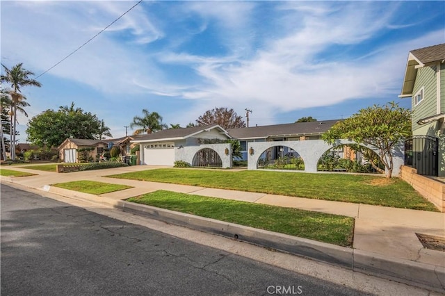 view of front of property with a front yard and a garage