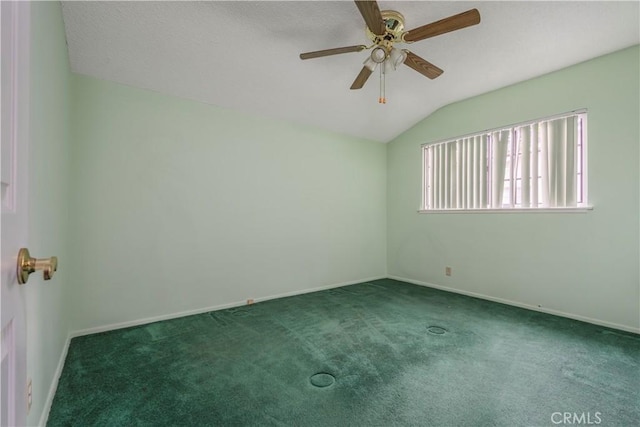 carpeted spare room with ceiling fan and vaulted ceiling