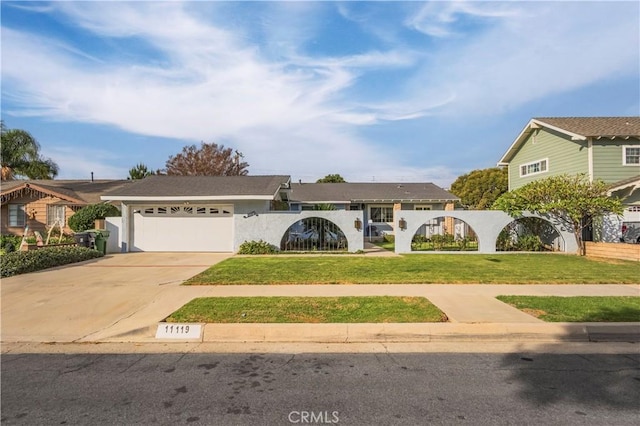 view of front of home with a garage and a front lawn