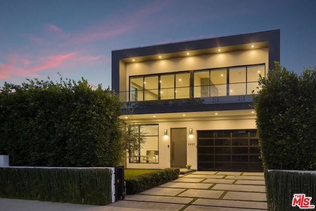 modern home featuring a balcony and a garage