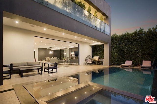 view of swimming pool with outdoor lounge area and a patio