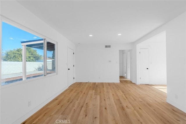 spare room featuring light hardwood / wood-style floors