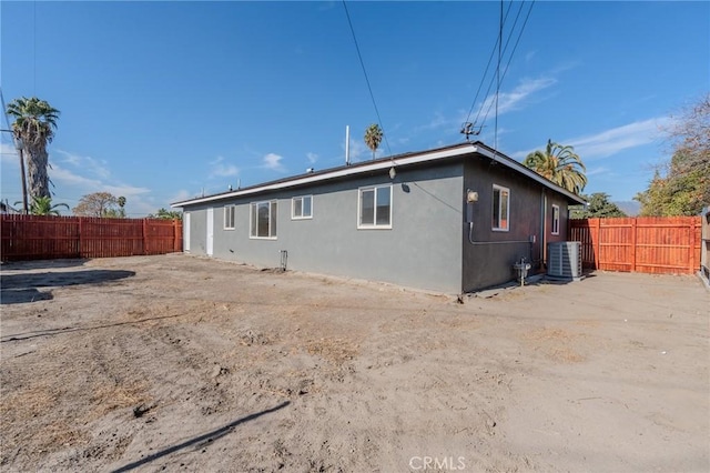 rear view of property with central AC unit