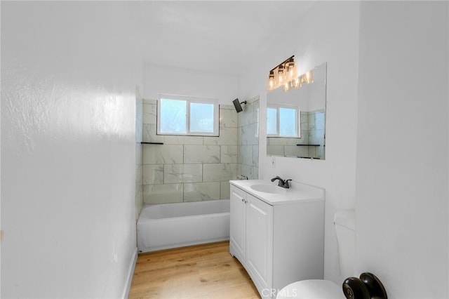 full bathroom featuring vanity, toilet, tiled shower / bath, and hardwood / wood-style flooring