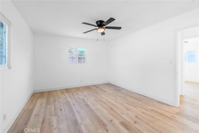 spare room with ceiling fan and light wood-type flooring