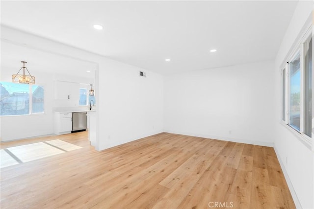 spare room featuring light wood-type flooring