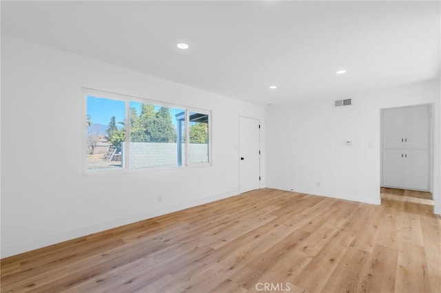 spare room with light hardwood / wood-style floors