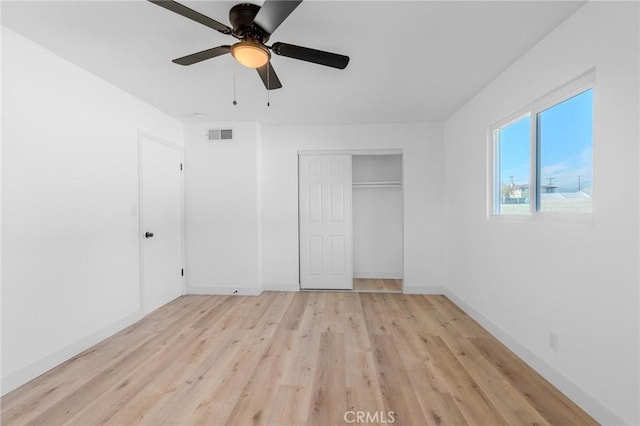 unfurnished bedroom with ceiling fan, a closet, and light hardwood / wood-style flooring