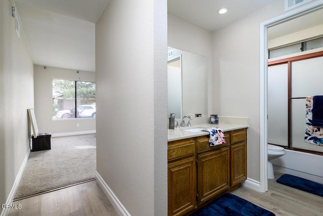 full bathroom with vanity, shower / bath combination with glass door, toilet, and wood-type flooring