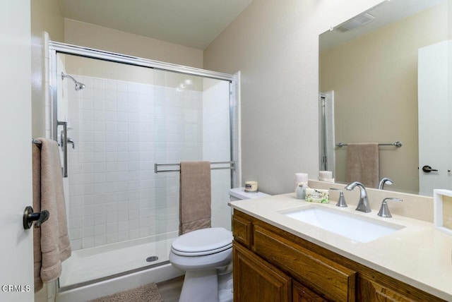 bathroom with vanity, toilet, and walk in shower