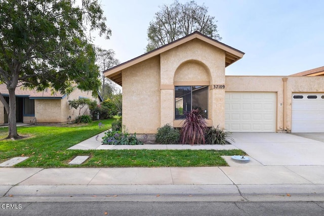 view of front of house with a front yard and a garage