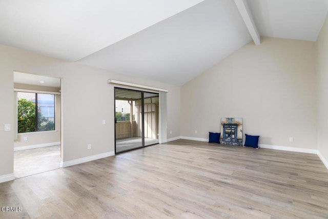 unfurnished room with vaulted ceiling with beams and light hardwood / wood-style flooring