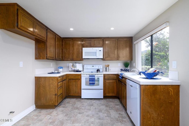 kitchen featuring white appliances and sink