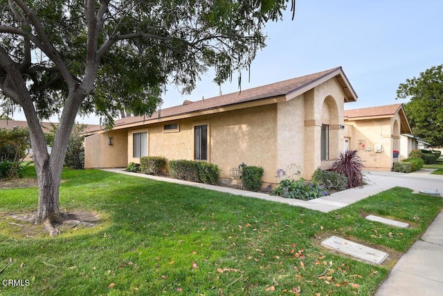 ranch-style house with a front lawn