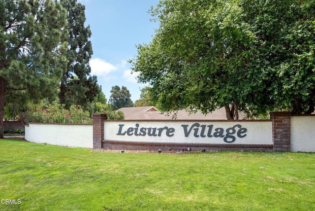 community sign featuring a lawn