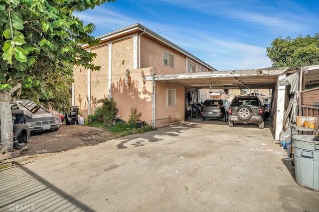 view of side of home featuring a carport