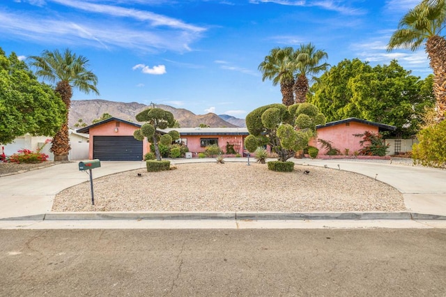 ranch-style home with a mountain view and a garage