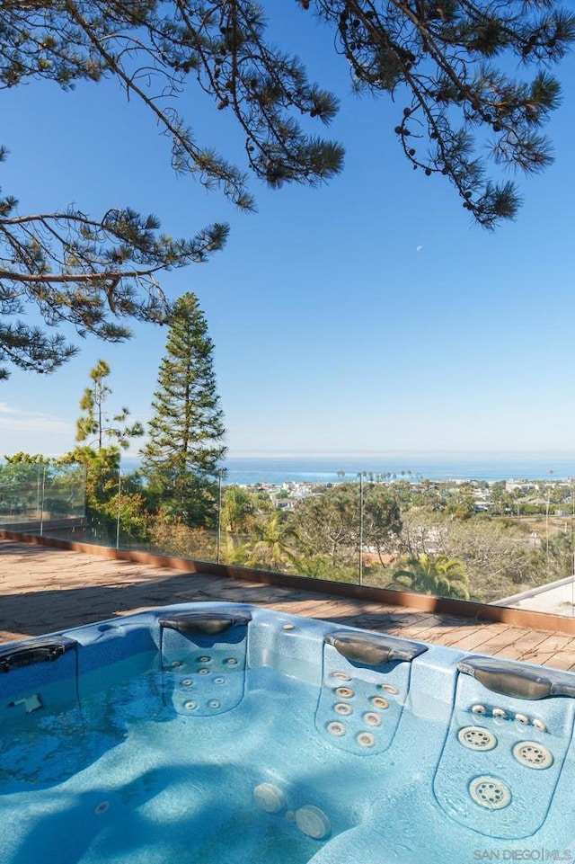 view of swimming pool with an outdoor hot tub