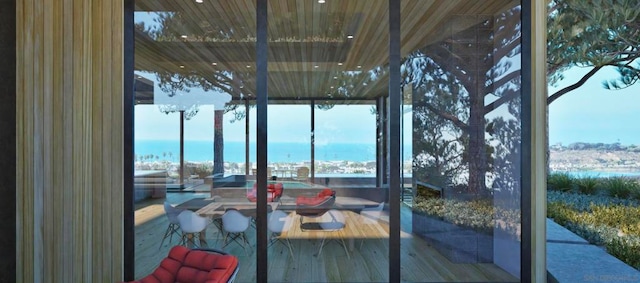 sunroom / solarium with a water view