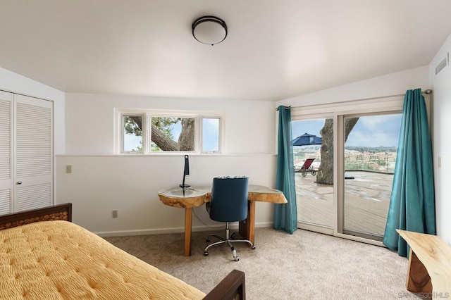 carpeted bedroom with access to exterior, a closet, and vaulted ceiling