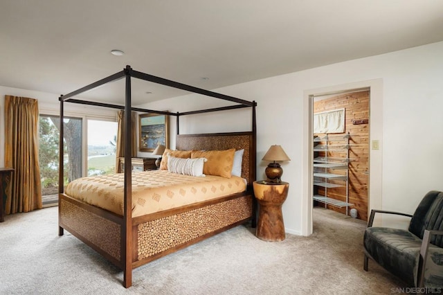 bedroom featuring carpet flooring and wooden walls