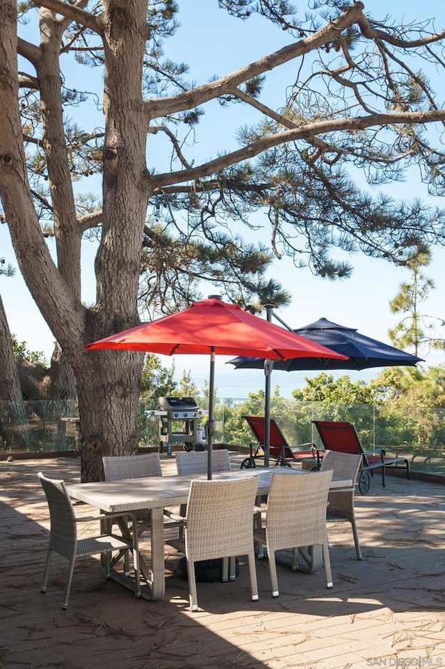 wooden deck featuring a grill