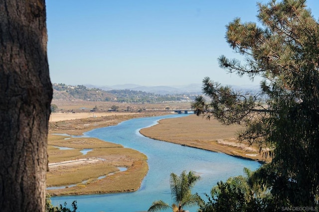 surrounding community featuring a water and mountain view