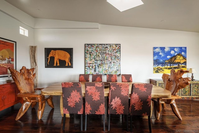 dining space with hardwood / wood-style flooring and vaulted ceiling