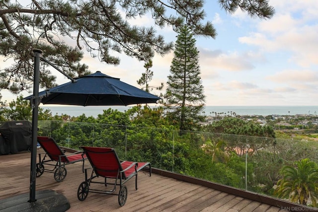 wooden deck featuring a water view and area for grilling